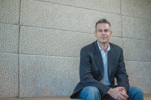 Michael Blank posing in a suite